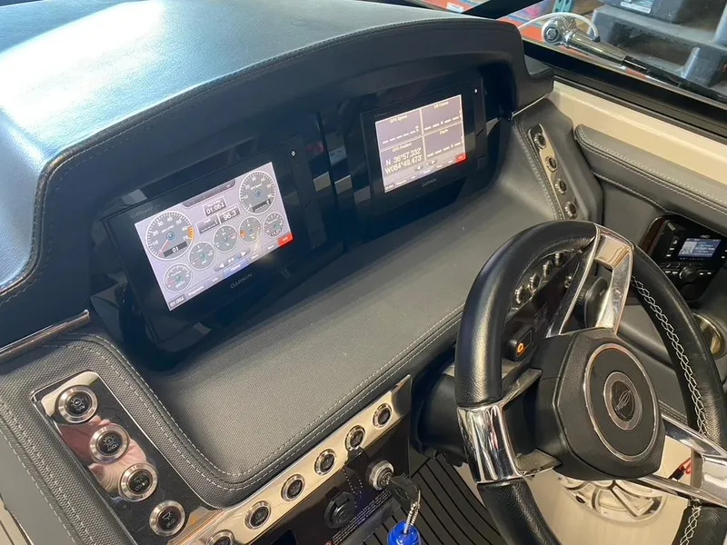 Slide: The Image of 2019 Chaparral 257 SSX dashboard with digital displays and steering wheel. - 35
