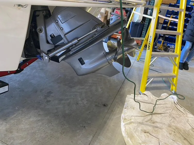 Slide: The Image of 2019 Chaparral 257 SSX boat propeller in a garage with ladder and tools nearby. - 37