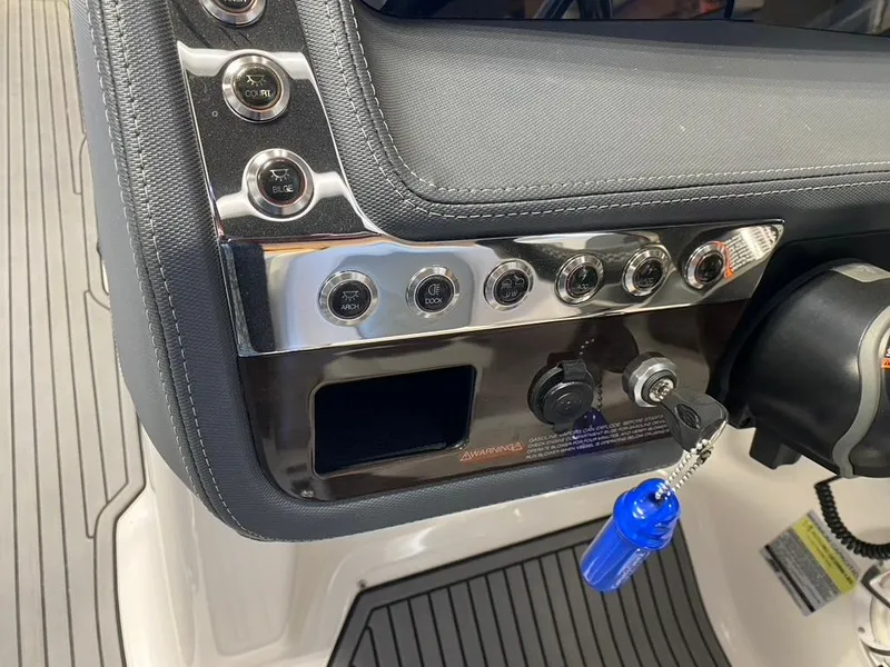 Slide: The Image of Control panel of a 2019 Chaparral 257 SSX boat with switches and key. - 38