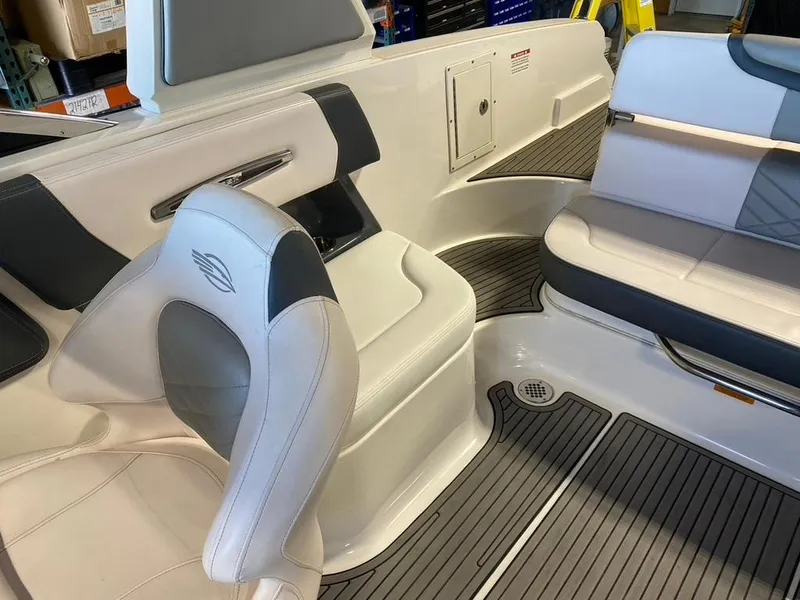 Slide: The Image of 2019 Chaparral 257 SSX boat interior with white and gray seating and flooring. - 6
