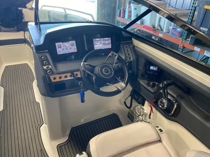 Slide: The Image of 2019 Chaparral 257 SSX boat cockpit with steering wheel and control panel. - 8