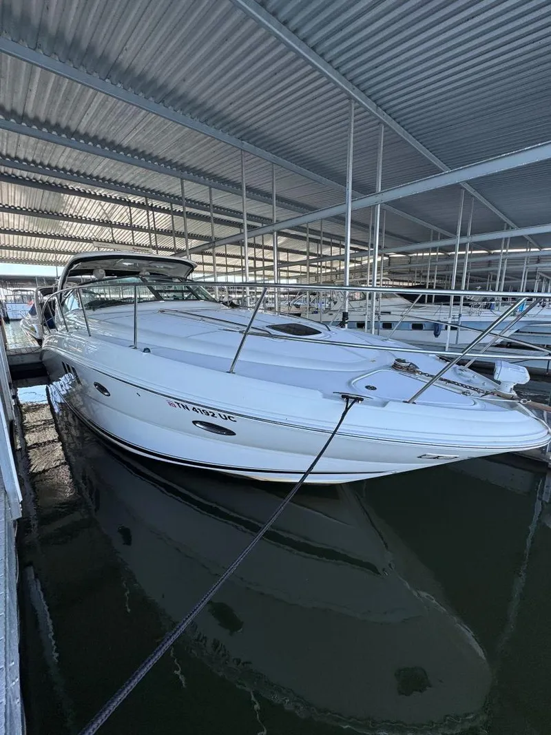 Slide: The Image of 2007 Sea Ray 38 Sundancer docked in a covered marina. - 11