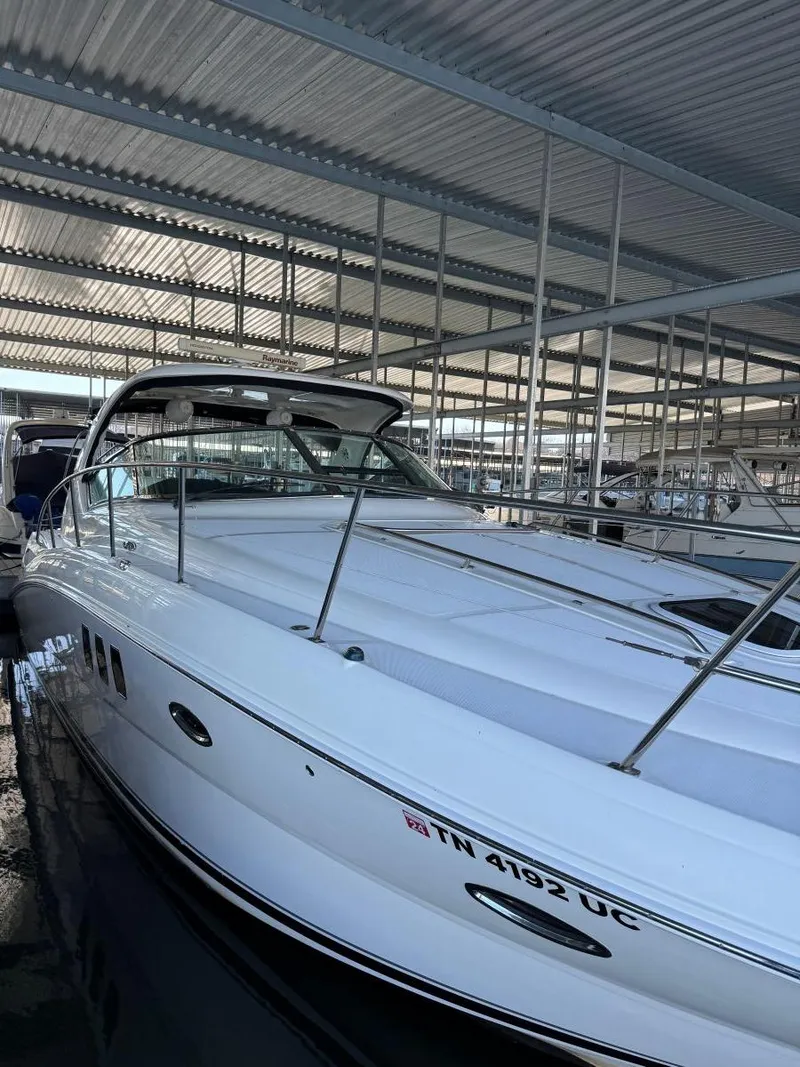 Slide: The Image of 2007 Sea Ray 38 Sundancer yacht docked in a covered marina. - 12