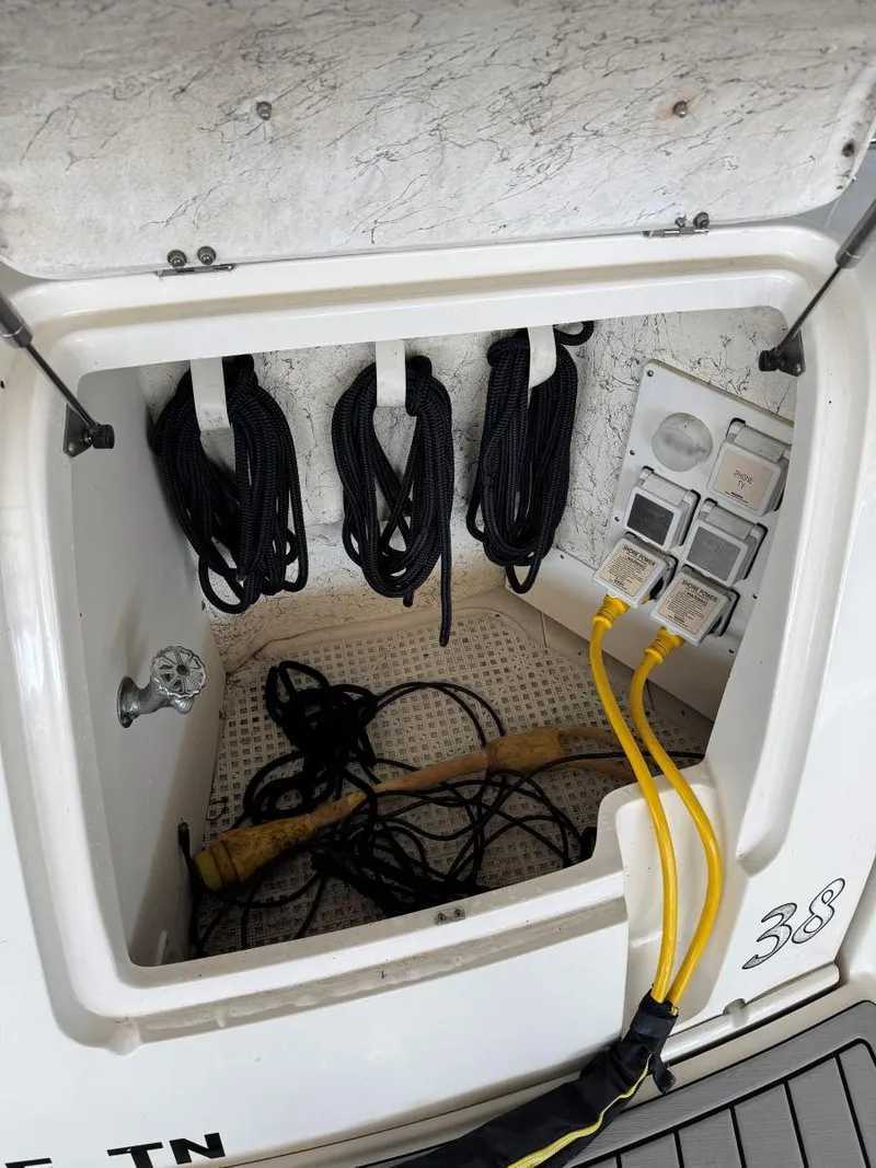 Slide: The Image of Storage compartment of 2007 Sea Ray 38 Sundancer with cables and ropes. - 14