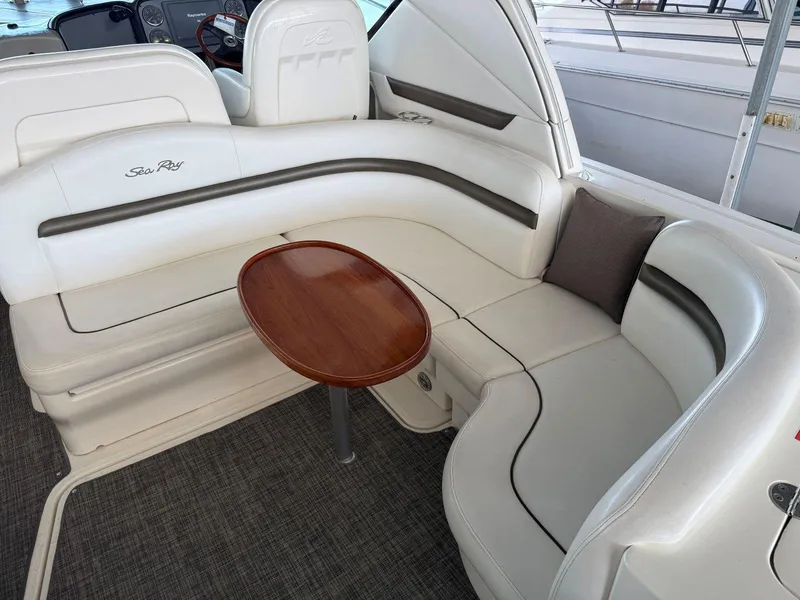 Slide: The Image of 2007 Sea Ray 38 Sundancer interior with white seating and wooden table. - 20