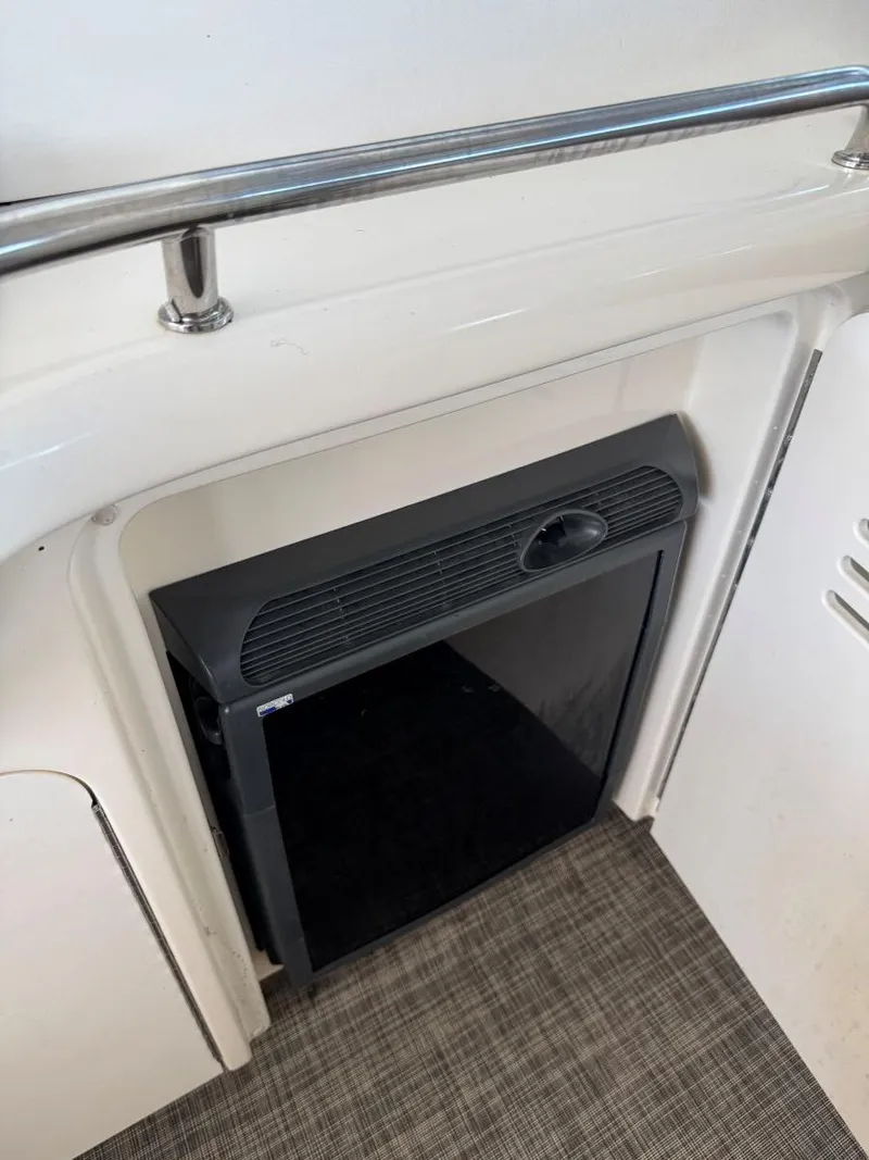 Slide: The Image of 2007 Sea Ray 38 Sundancer interior with compact black refrigerator. - 23