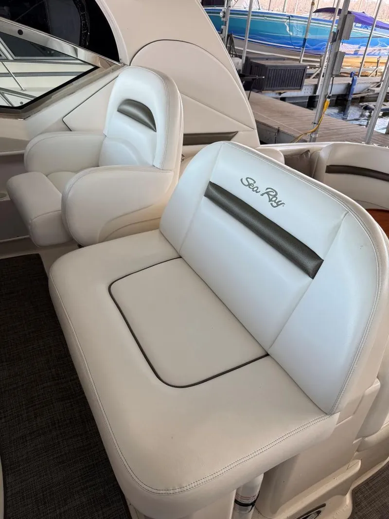 Slide: The Image of 2007 Sea Ray 38 Sundancer boat seats, white leather, docked in marina. - 24