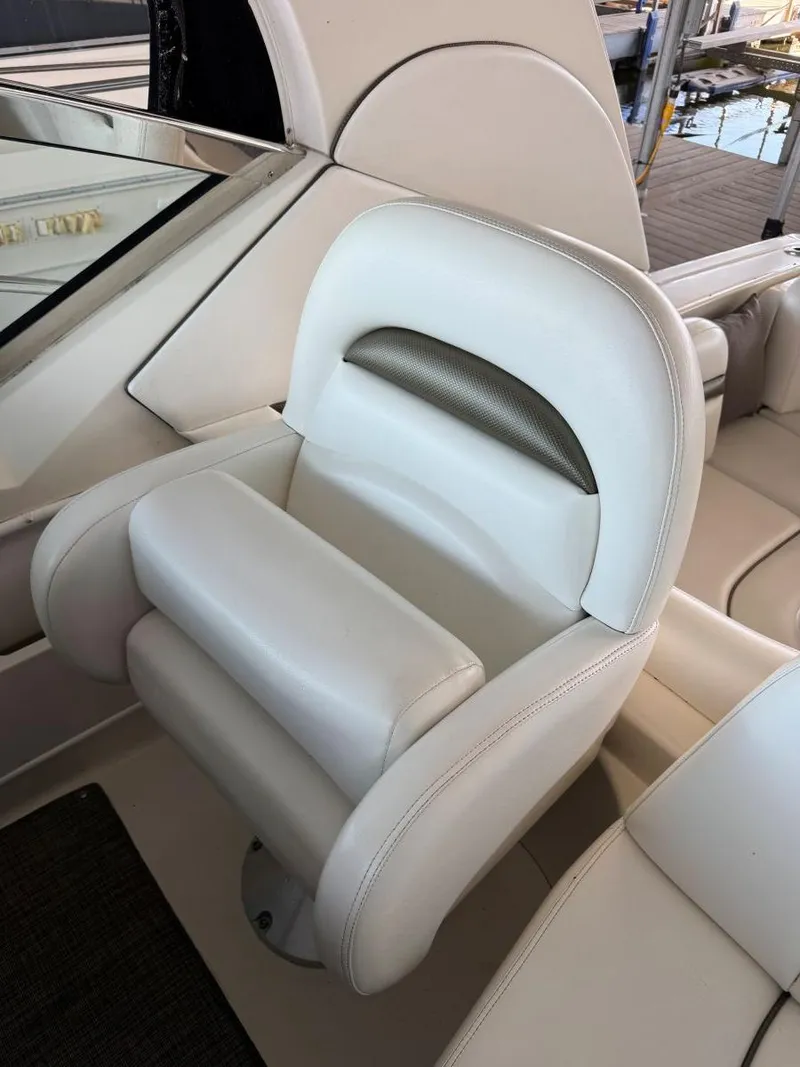 Slide: The Image of 2007 Sea Ray 38 Sundancer helm seat, white leather, luxurious design. - 28