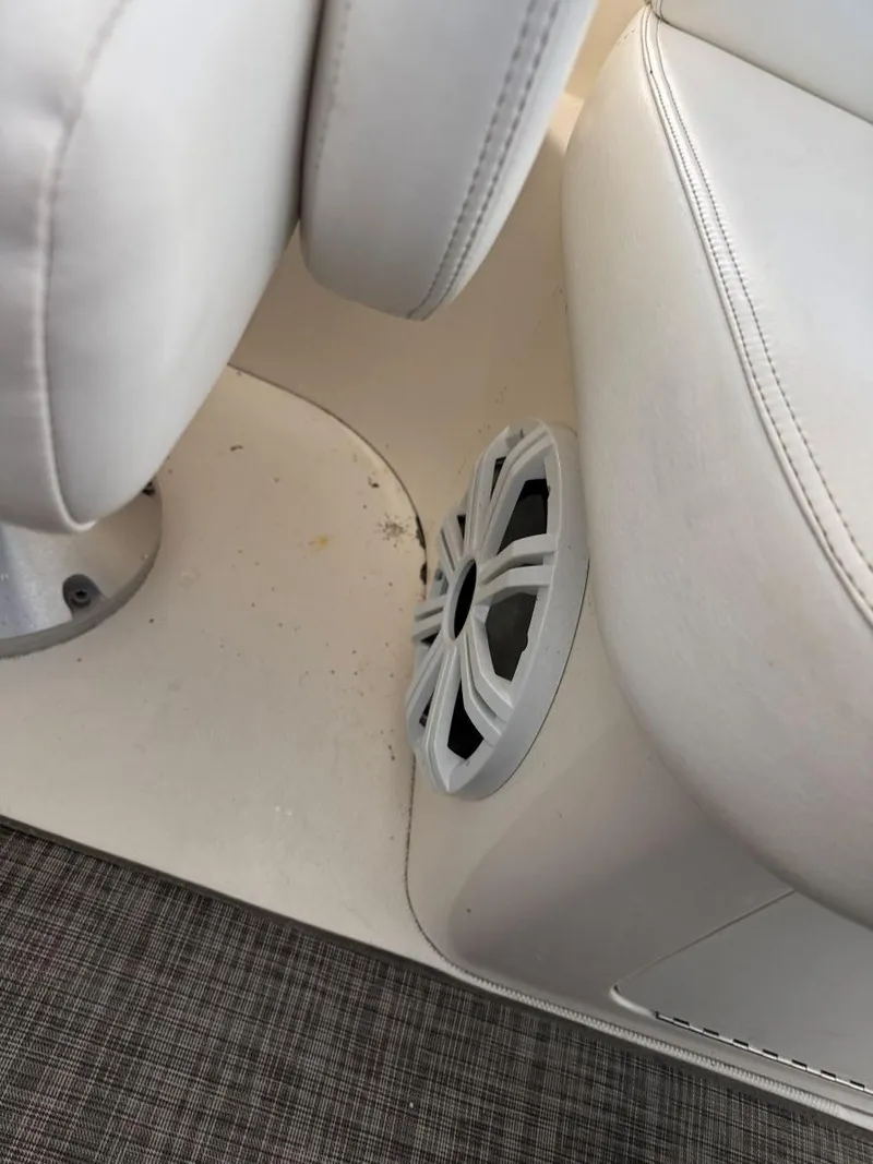 Slide: The Image of 2007 Sea Ray 38 Sundancer interior with white seating and speaker detail. - 29