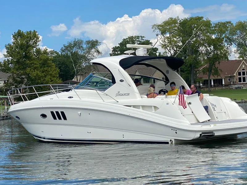 Slide: The Image of 2007 Sea Ray 38 Sundancer yacht on a lake with passengers enjoying the view. - 3