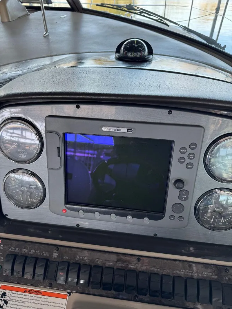 Slide: The Image of 2007 Sea Ray 38 Sundancer dashboard with navigation system and gauges. - 32