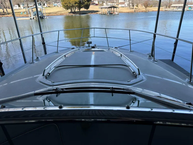 Slide: The Image of 2007 Sea Ray 38 Sundancer yacht docked on a calm lake. - 34