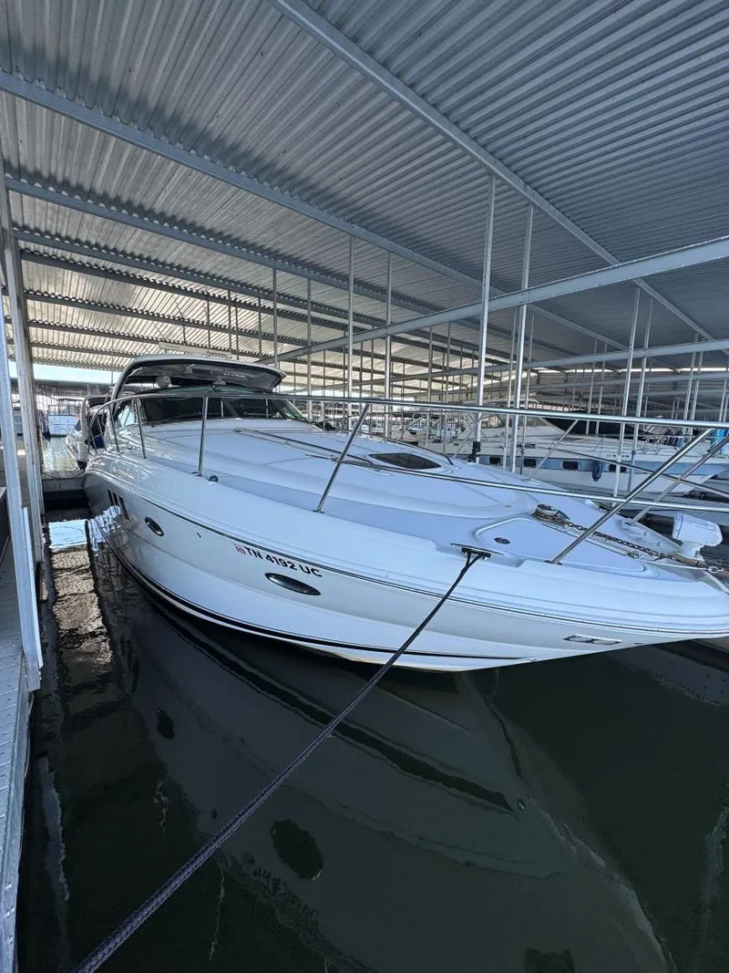 Slide: The Image of 2007 Sea Ray 38 Sundancer docked in a covered marina. - 39