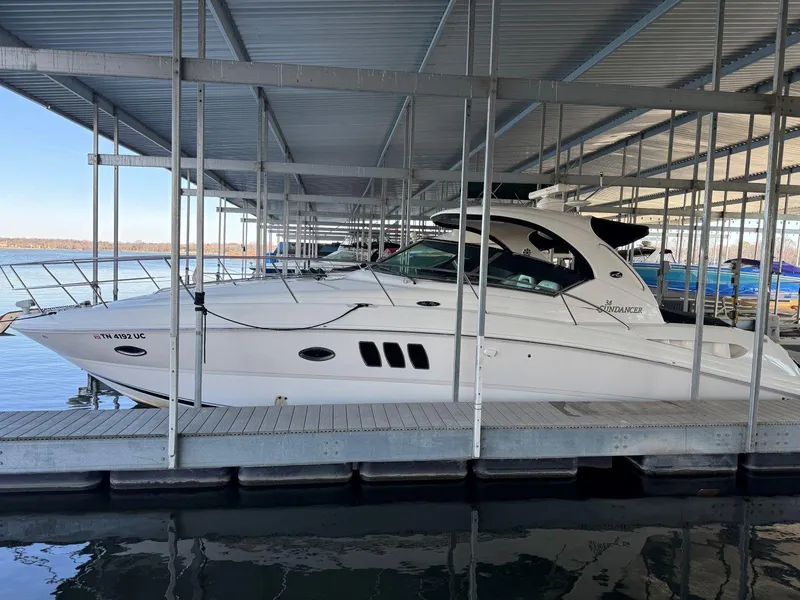 Slide: The Image of 2007 Sea Ray 38 Sundancer yacht docked in a covered marina. - 42