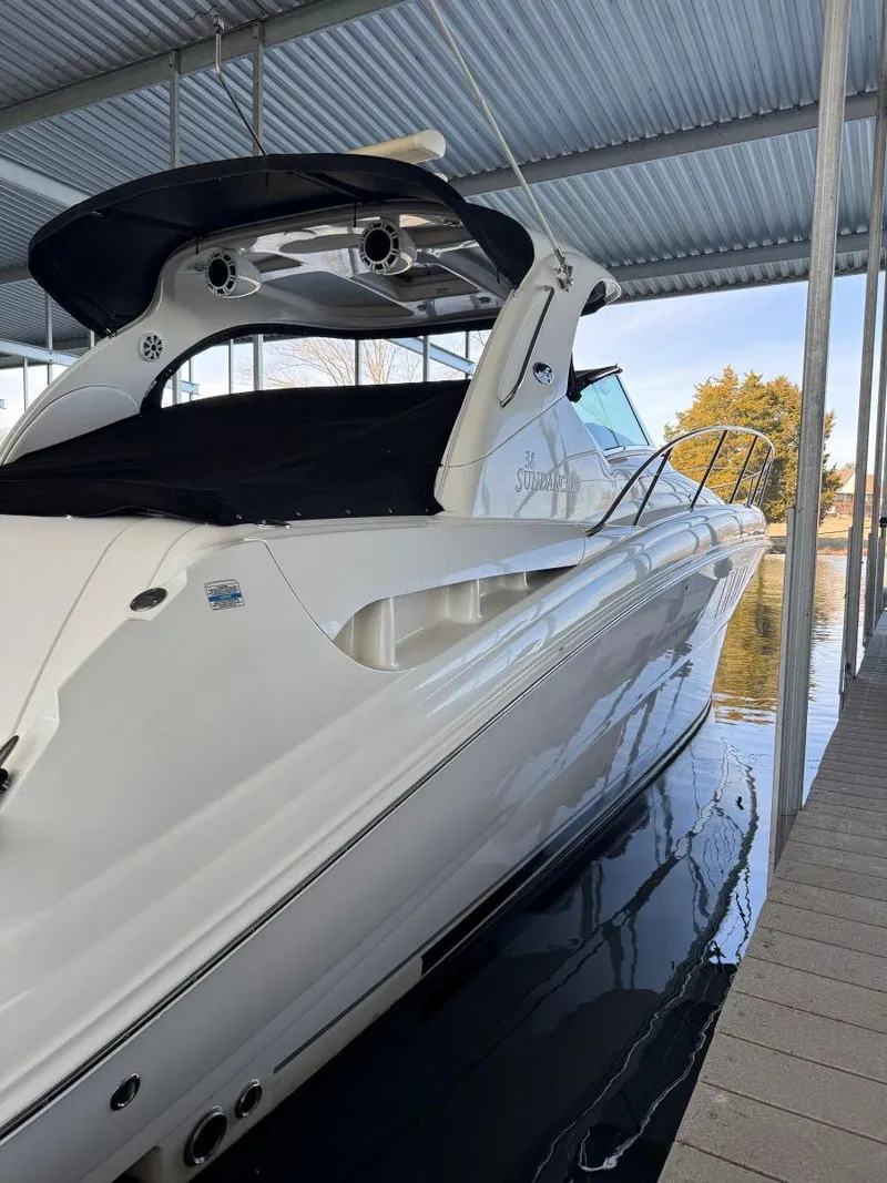 Slide: The Image of 2007 Sea Ray 38 Sundancer yacht docked under a covered marina. - 45