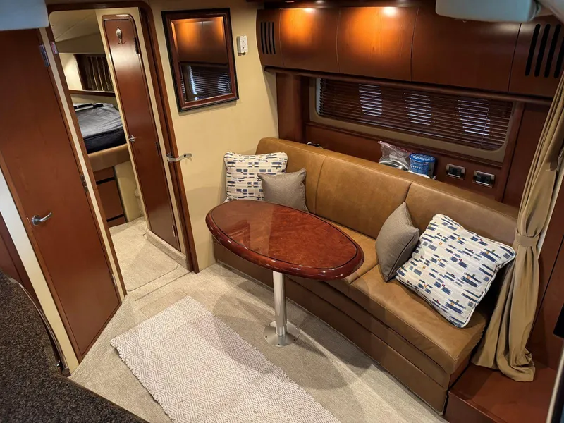 Slide: The Image of Interior of 2007 Sea Ray 38 Sundancer yacht with cozy seating and elegant wood finishes. - 48