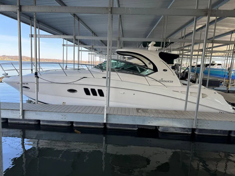 Slide: The Image of 2007 Sea Ray 38 Sundancer yacht docked in a marina under a covered shelter. - 7