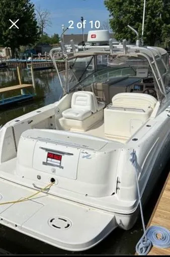 Slide: The Image of 2000 Sea Ray 290 Amberjack boat docked, featuring spacious seating and a "For Sale" sign. - 1