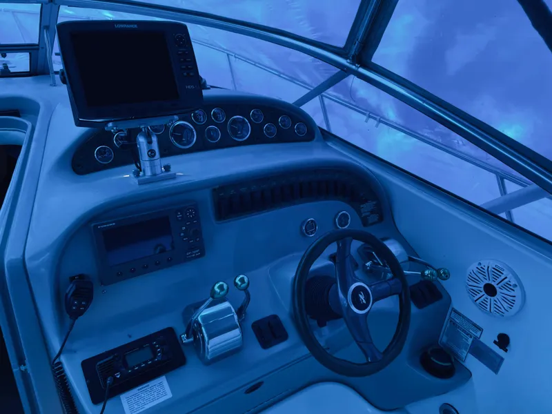 Slide: The Image of Cockpit of 2000 Sea Ray 290 Amberjack with steering wheel and navigation equipment. - 16