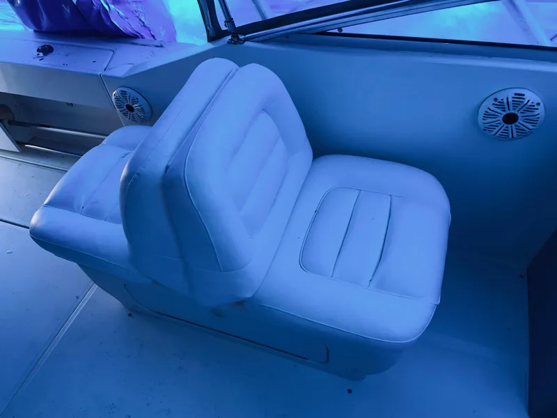Slide: The Image of White leather seat on 2000 Sea Ray 290 Amberjack boat interior. - 19