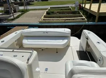 Slide: The Image of 2000 Sea Ray 290 Amberjack boat interior with white seating and dock view. - 2