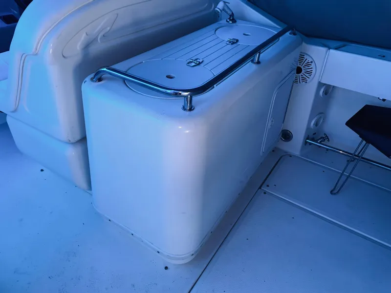 Slide: The Image of Interior view of a 2000 Sea Ray 290 Amberjack boat, featuring seating and storage. - 20