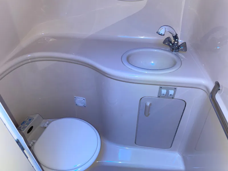 Slide: The Image of 2000 Sea Ray 290 Amberjack boat bathroom with sink and toilet. - 22