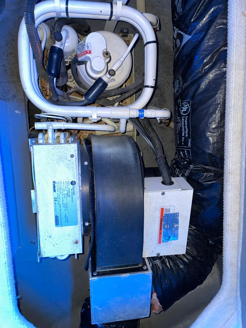 Slide: The Image of Engine compartment of a 2000 Sea Ray 290 Amberjack boat, showing mechanical components. - 26