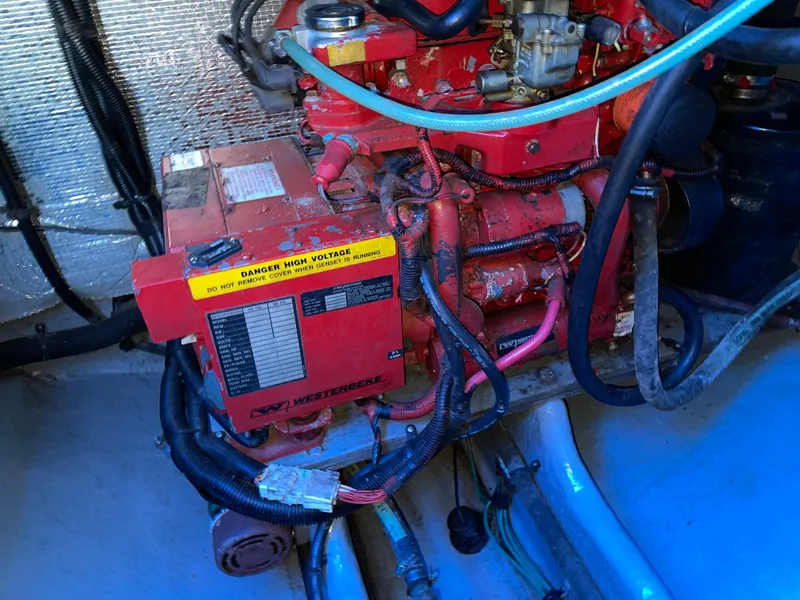 Slide: The Image of Engine compartment of 2000 Sea Ray 290 Amberjack with red marine engine components. - 8