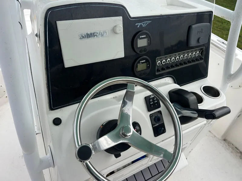 Slide: The Image of 2016 Tidewater 210 LXF boat console with steering wheel and controls. - 10