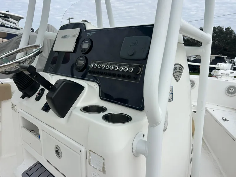 Slide: The Image of Center console of a 2016 Tidewater 210 LXF boat with steering wheel and controls. - 11