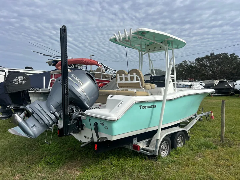 Slide: The Image of 2016 Tidewater 210 LXF boat on trailer, featuring Yamaha outboard motor, parked on grass. - 2
