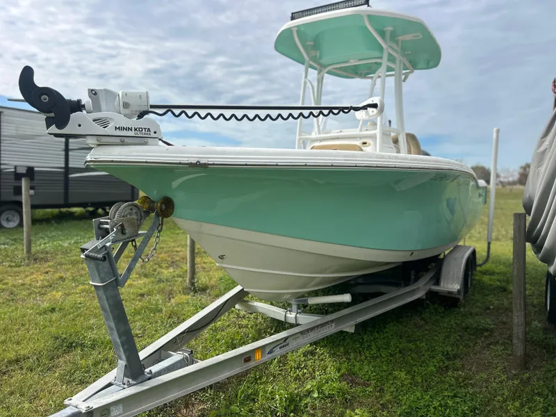 Slide: The Image of 2016 Tidewater 210 LXF boat on trailer, light blue hull, parked on grass. - 5