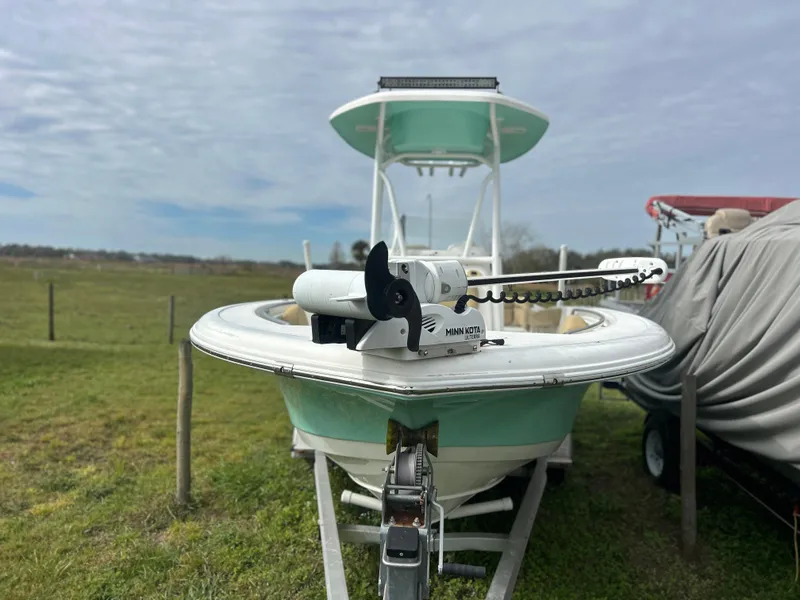Slide: The Image of 2016 Tidewater 210 LXF boat with Minn Kota trolling motor, parked on grass. - 6
