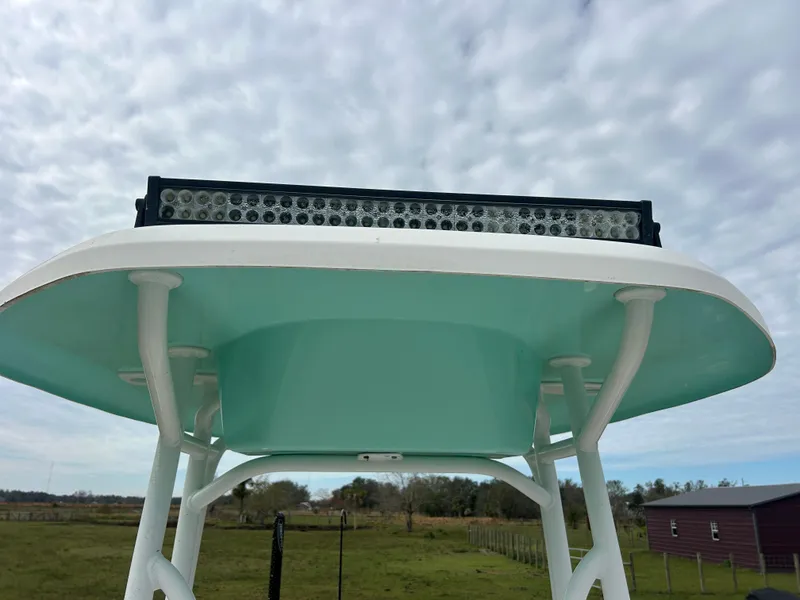 Slide: The Image of Tidewater 210 LXF 2016 boat with T-top and LED light bar under cloudy sky. - 7