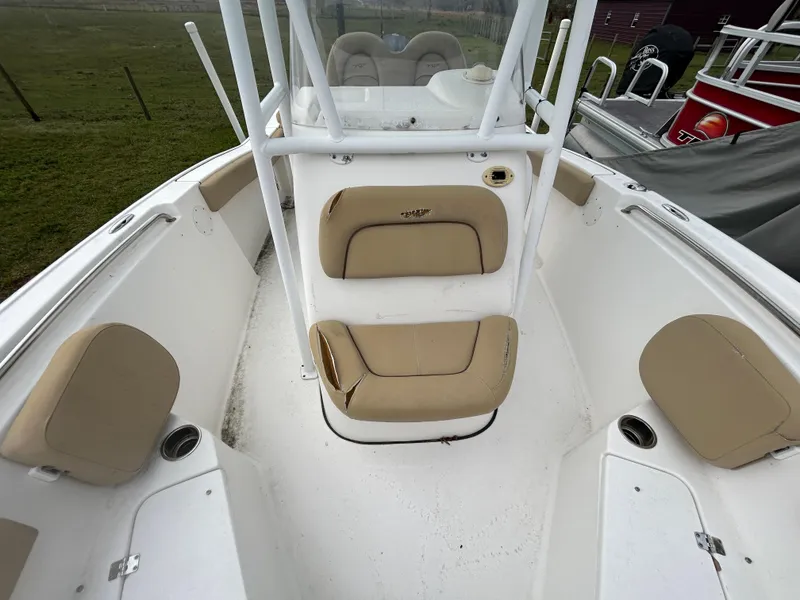 Slide: The Image of 2016 Tidewater 210 LXF boat interior with beige seating and white deck. - 9