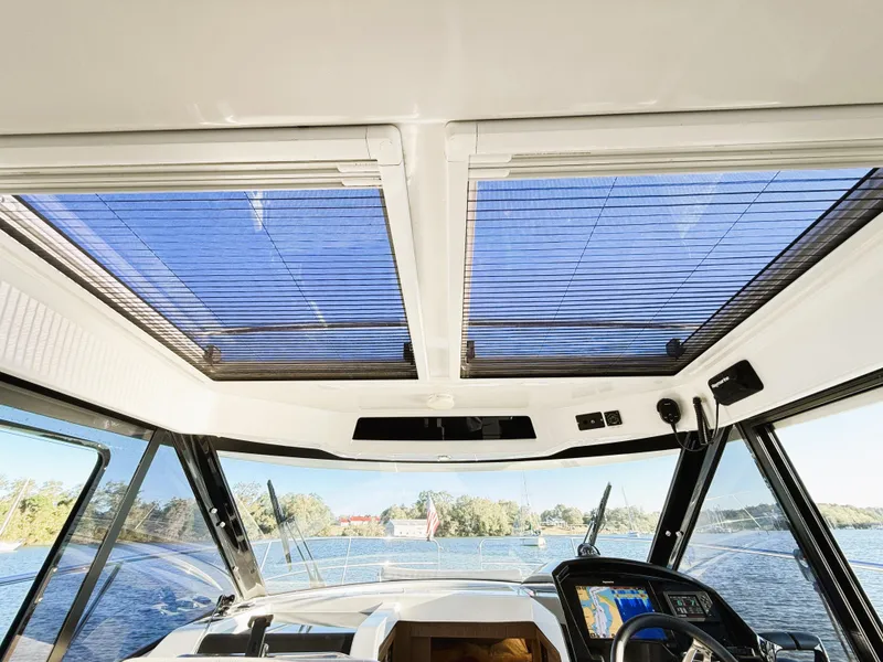 Slide: The Image of Interior view of 2021 Jeanneau NC 895 boat with panoramic windows and modern dashboard. - 10