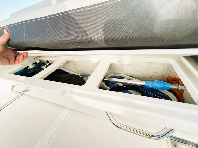 Slide: The Image of Storage compartment on a 2021 Jeanneau NC 895 boat, showing organized equipment. - 11