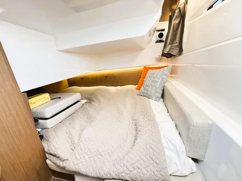 Slide: The Image of Cozy cabin interior of 2021 Jeanneau NC 895 with comfortable bedding and modern design. - 13
