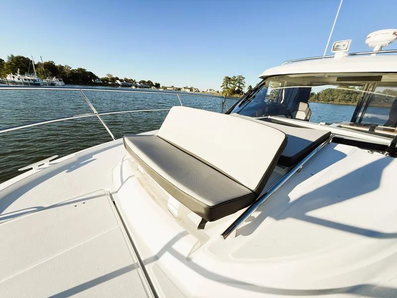 Slide: The Image of 2021 Jeanneau NC 895 boat with sun deck seating on calm water. - 16