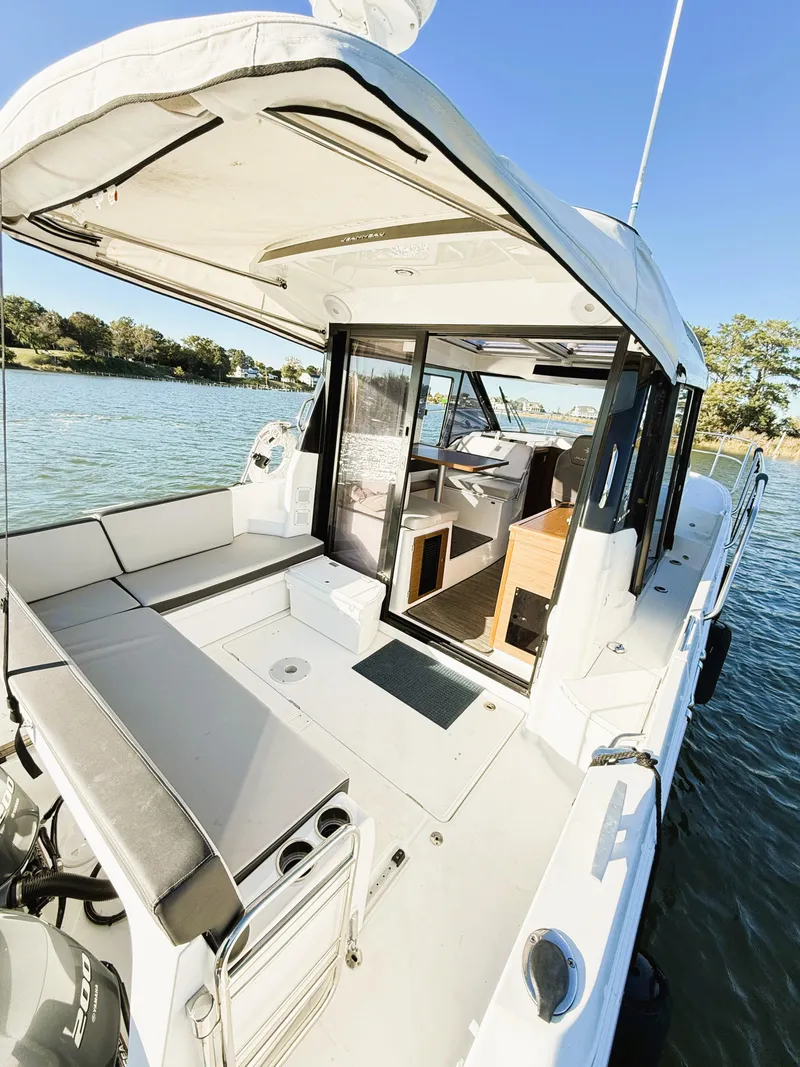 Slide: The Image of 2021 Jeanneau NC 895 boat with spacious deck and modern interior on a sunny day. - 18