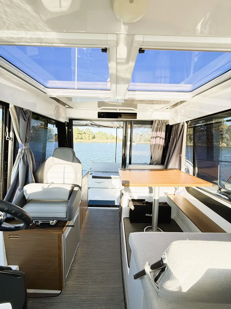 Slide: The Image of Interior of 2021 Jeanneau NC 895 boat with panoramic windows and modern seating. - 23