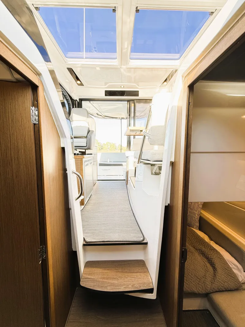Slide: The Image of Interior view of 2021 Jeanneau NC 895 boat, featuring modern design and cozy cabin space. - 24