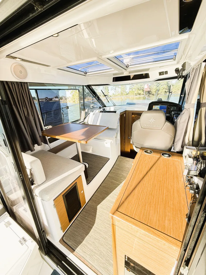 Slide: The Image of Interior of 2021 Jeanneau NC 895 boat with modern seating and navigation area. - 26