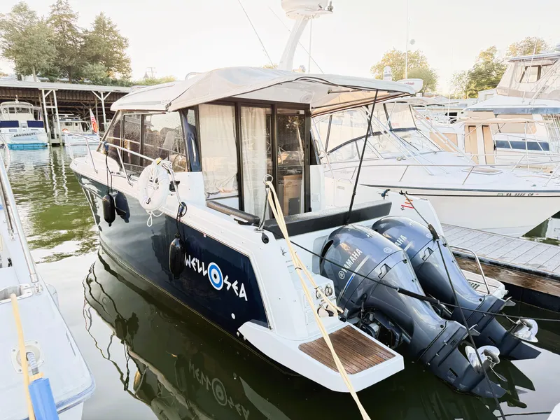 Slide: The Image of 2021 Jeanneau NC 895 boat docked with twin outboard motors. - 27