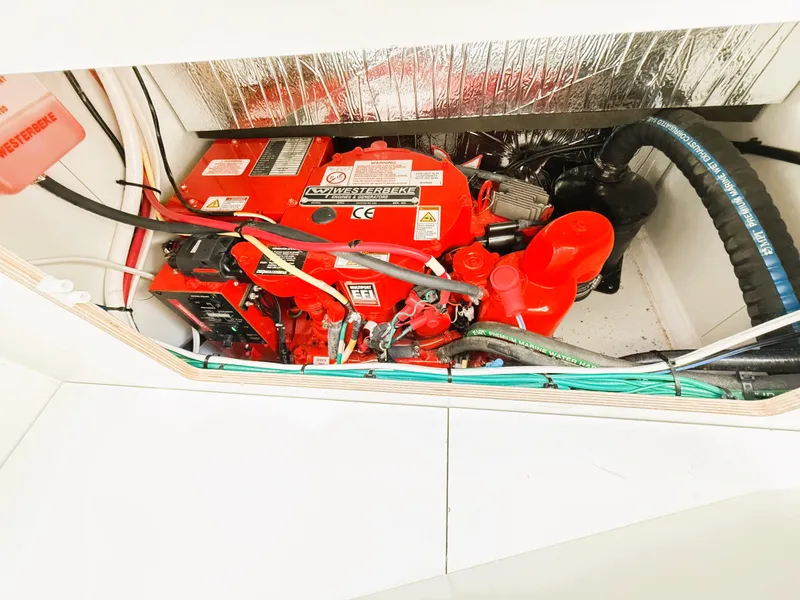 Slide: The Image of Engine compartment of 2021 Jeanneau NC 895 boat, featuring a red engine. - 38