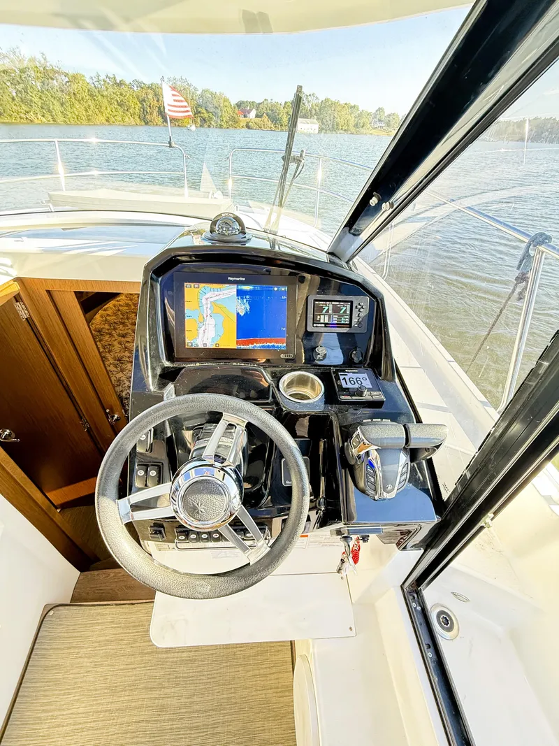 Slide: The Image of 2021 Jeanneau NC 895 helm with navigation system on a calm lake. - 6