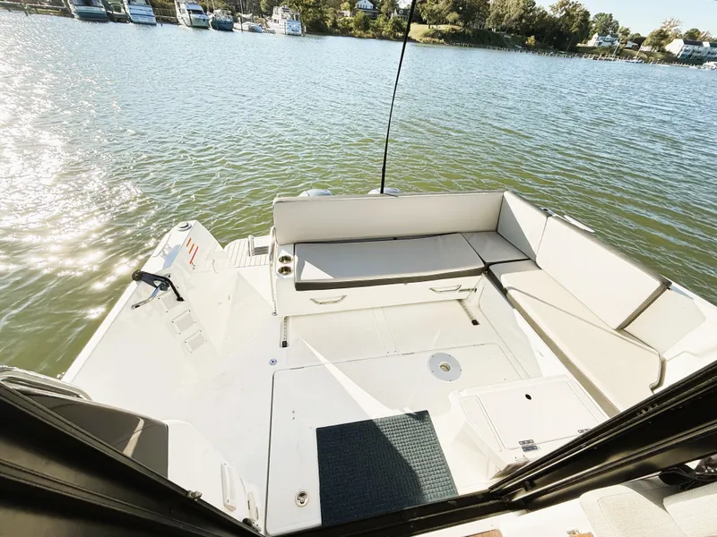 Slide: The Image of 2021 Jeanneau NC 895 boat deck with seating, overlooking a serene waterfront. - 7