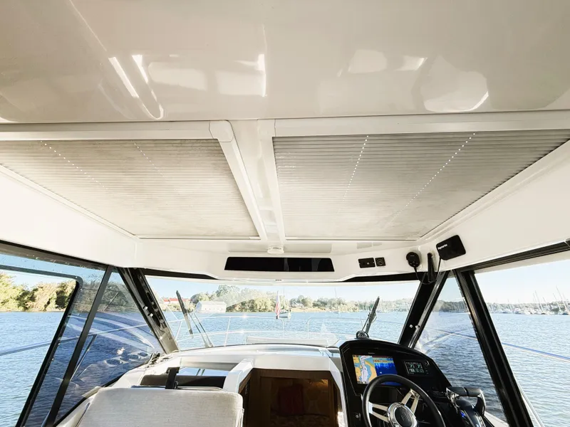 Slide: The Image of Interior view of 2021 Jeanneau NC 895 boat cockpit with panoramic windows. - 9