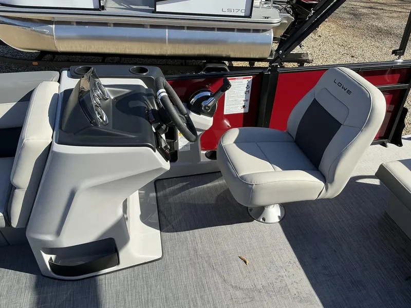 Slide: The Image of Captain's seat and helm of 2025 Lowe LS 170 boat, featuring modern design and controls. - 4